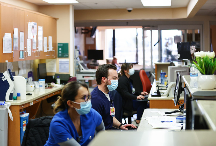 Registered nurses work on their computers.