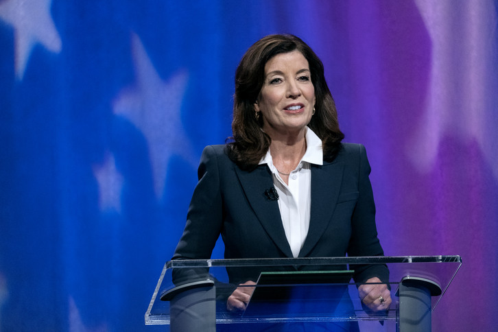 Kathy Hochul speaks at a lectern during a debate.