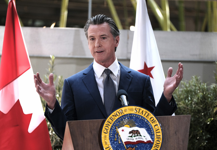 California Gov. Gavin Newsom answers questions at a news conference.