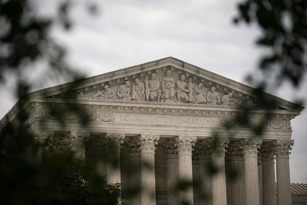 The U.S. Supreme Court is seen through trees in Washington, D.C.