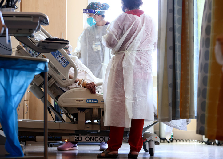 Nurses care for a COVID-19 patient in a hospital. 