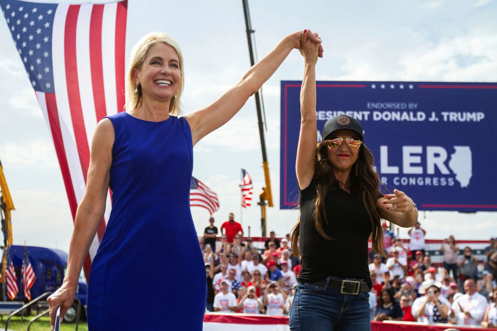 Rep. Mary Miller (R-Ill.), left, is joined by Rep. Lauren Boebert (R-Colo.) on stage.