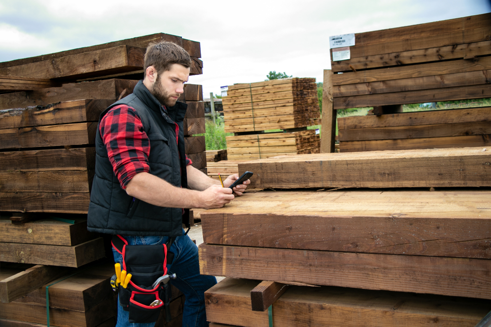 man working outside on phone