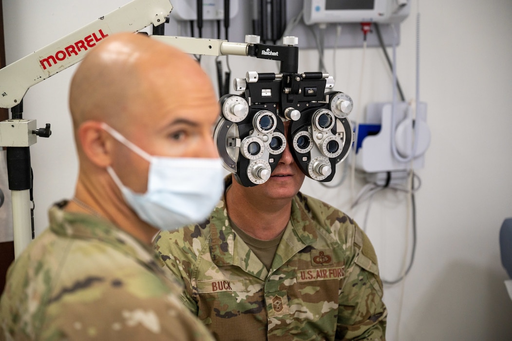 Image of two Airmen conducting a vision test.