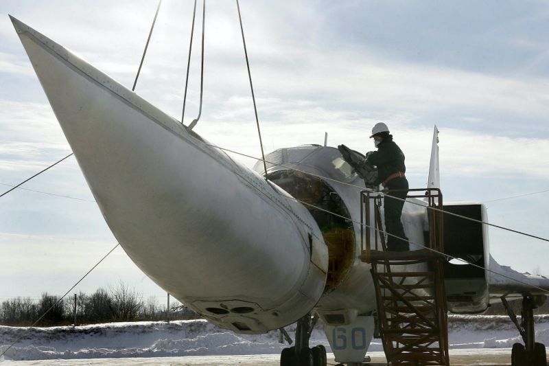 A worker cuts the nose off the last Ukraine's Tupolev-22M3, the Soviet-made strategic aircraft able to carry nuclear weapons at a military base in Poltava, Ukraine on Jan. 27, 2006. A total of 60 aircraft were destroyed  according to the USA-Ukrainian disarmament agreement.