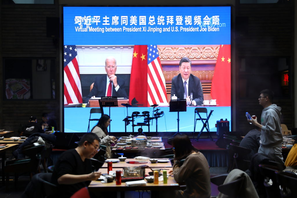 Screen shows Chinese President Xi Jinping attending a virtual meeting with U.S. President Joe Biden via video link, at a r...