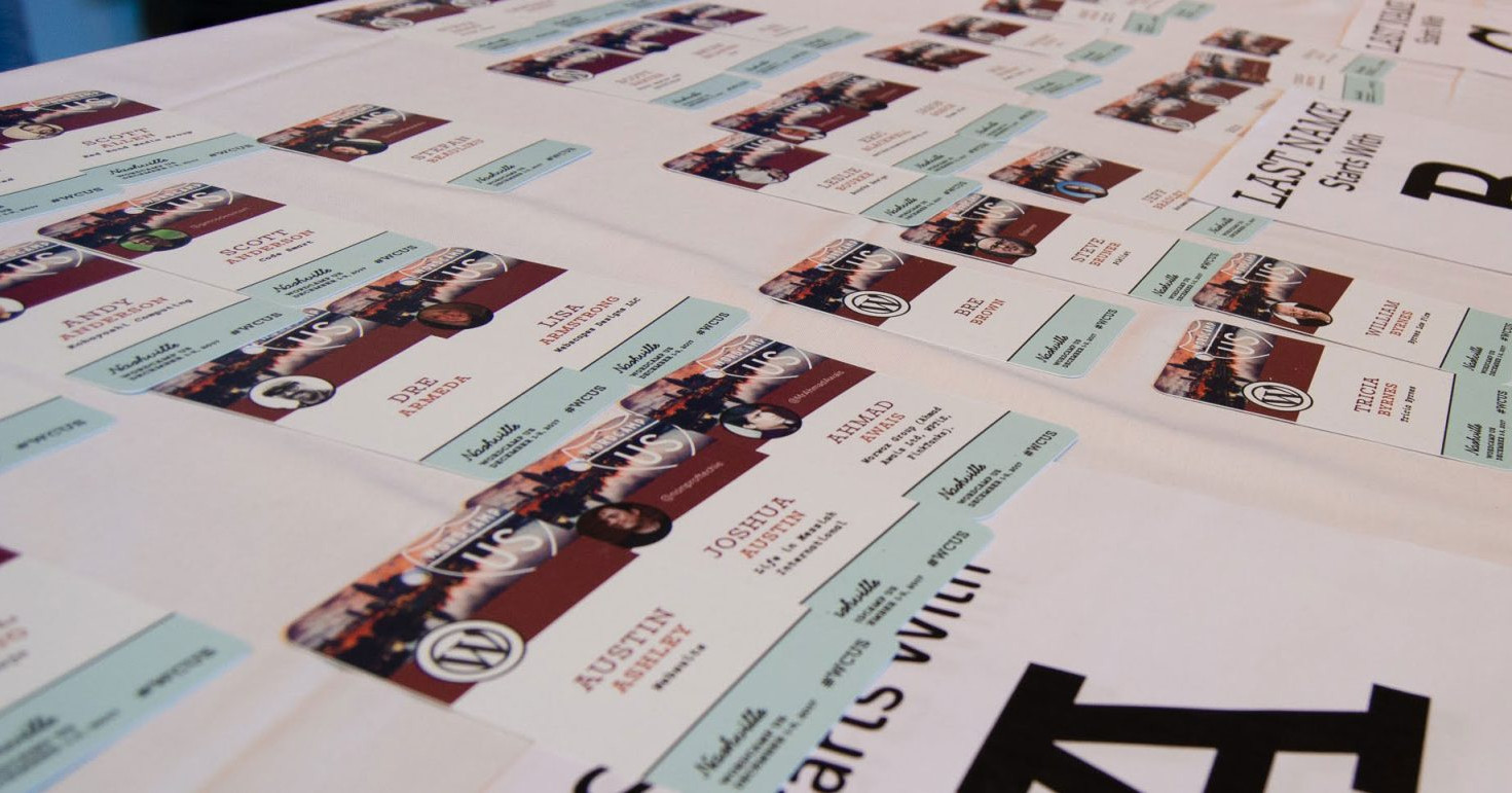 A table full of WordCamp registration badges. Photo Credit: David Needham