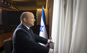  Prime Minister Naftali Bennett is seen looking out of his office window.