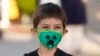 Kindergarten student Adam Shallbetter poses as his mother takes a picture after arriving at Whittier Elementary School, Aug. 24, 2021, in Salt Lake City, Utah.