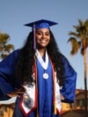 Harvard-bound Abia Khan, valedictorian of her high school class and the daughter of immigrants from Bangladesh, poses in her cap and gown in Laveen, Arizona, on May 5, 2020.