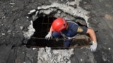 Ukrainian rescuers search for and retrieve the remains of Russian shells on the roof of a high-rise building damaged by Russian shelling in one of the residential areas of Kharkiv, Ukraine, June 30, 2022. 