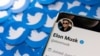 FILE - Elon Musk's Twitter profile is seen on a smartphone placed on printed Twitter logos in this picture illustration taken April 28, 2022. 