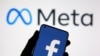 A smartphone with Facebook's logo is seen in front of displayed Facebook's new rebrand logo Meta in this illustration taken Oct. 28, 2021. Meta also owns Instagram.