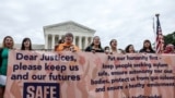 Demonstrators call on the United States Supreme Court to overturn the "Remain in Mexico" policy in response to Biden v. Texas, in Washington, June 21, 2022. 