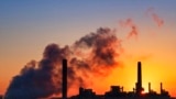 FILE - A coal-fired power plant is silhouetted against the morning sun in Wyoming in July 2018.