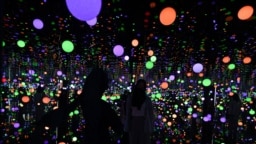 Visitors visit an art installation by Japanese artist Yayoi Kusama entitled "Infinity Mirrored Room - Brilliance of the Souls" at the Museum MACAN (Modern and Contemporary Art Museum) in Jakart, Malaysia, June 30, 2022. 