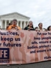 Demonstrators call on the United States Supreme Court to overturn the "Remain in Mexico" policy in response to Biden v. Texas, in Washington, June 21, 2022. 