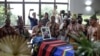 Xukuru's Indigenous people sing a prayer in honor of the Brazilian Indigenous expert Bruno Pereira next to his coffin during his funeral at the Morada da Paz Cemetery in Paulista, Pernambuco state, Brazil, on June 24, 2022.