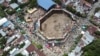 In this image taken from video, spectators agglomerate around the wooden stands that collapsed during a bullfight in El Espinal, Tolima state, Colombia, June 26, 2022. According to authorities, four people died and more than 300 were injured in the collapse.