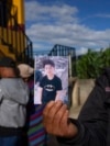 A man shows a portrait of Wilmer Tulul, in Tzucubal, Guatemala, June 29, 2022. Wilmer and his cousin were among the dead discovered inside a semitrailer on the edge of San Antonio, Texas, on June 27, in a deadly case of human smuggling.