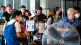 Travelers wait in a security line at the Philadelphia International Airport ahead of the Independence Day holiday weekend in Philadelphia, July 1, 2022. 