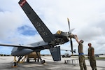 U.S. Air Force members of the 119th Wing adjust propeller weight during MQ-9 preflight checks at Andersen Air Force Base, Guam, during Exercise Valiant Shield May 27, 2022. The 12-day joint field training exercise enhanced integration between U.S. forces during joint operations at sea, on land, in air, and in cyberspace.