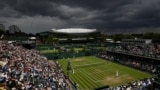 Netherlands' Tim van Rijthoven and Georgia's Nikoloz Basilashvili compete in a third round Wimbledon match at the All England Lawn Tennis and Croquet Club, London