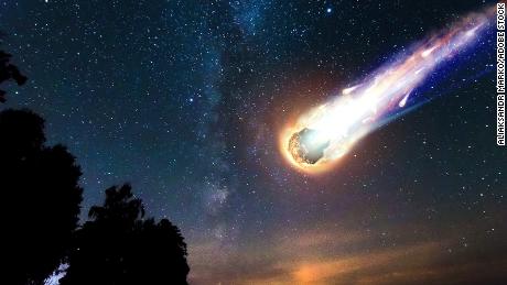 A comet, an asteroid, a meteorite falls to the ground against a starry sky. Attack of the meteorite. Meteor Rain. Kameta tail. End of the world.