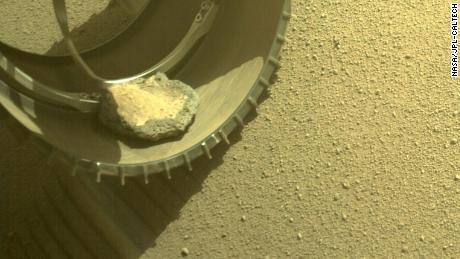 Perseverance rover gained a new traveling companion when a rock hopped into the rover&#39;s wheel four months ago. 