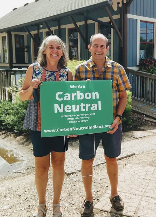 Carbon Neutral Indiana supporters holding a yard sign