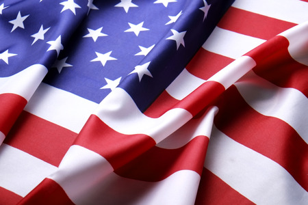 Close up of ruffled American flag. Patriots day, memorial weekend, veterans day, presidents day, independence day background. United States of America national stars and stripes symbol. Copy space.