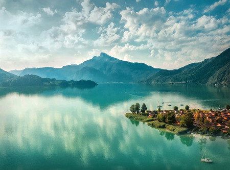 Beautiful morning sunrise view on the mountain lake in Alps under sunlight in summer. Aerial photography from a bird's eye view.