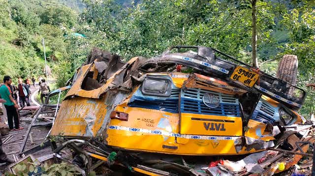 <p>The wreckage of a passenger that bus slid off a mountain road and fell into a deep gorge in Kullu, India on Monday</p>