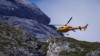 A helicopter participates in search and rescue operations at the site of a deadly collapse of parts of a mountain glacier in the Italian Alps, at the Dolomites' Marmolada ridge, Italy, July 5, 2022.