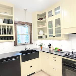 Cream cabinets with black countertops in kitchen