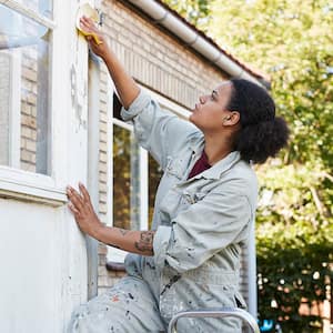 Woman sanding outside of house