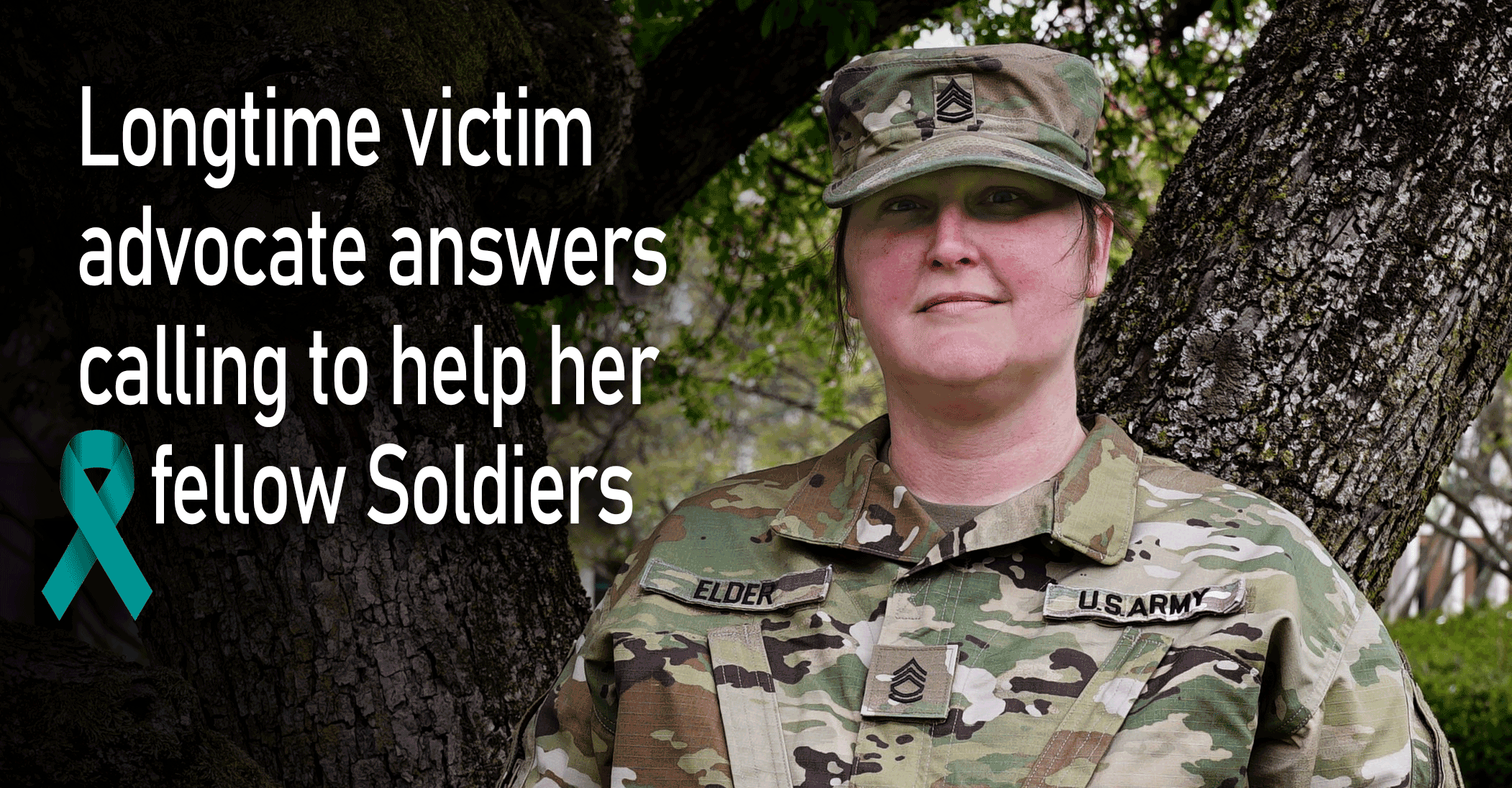 Sgt. 1st Class Kindra Elder standing by tree.