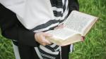 A Jewish man praying with a tallis (prayer shawl).