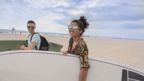 Two people enjoying 'Summer Fridays' at the beach