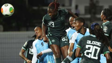 Christy Ucheibe heads at goal for Nigeria