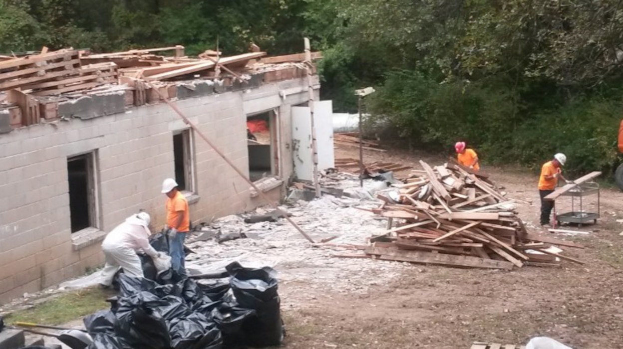 Bhate employees work to deconstruct a chapel - one of three buildings selected for the deconstruction pilot program - on Fort Leonard Wood, Missouri. Materials from the chapel were salvaged for reuse or recycle. 