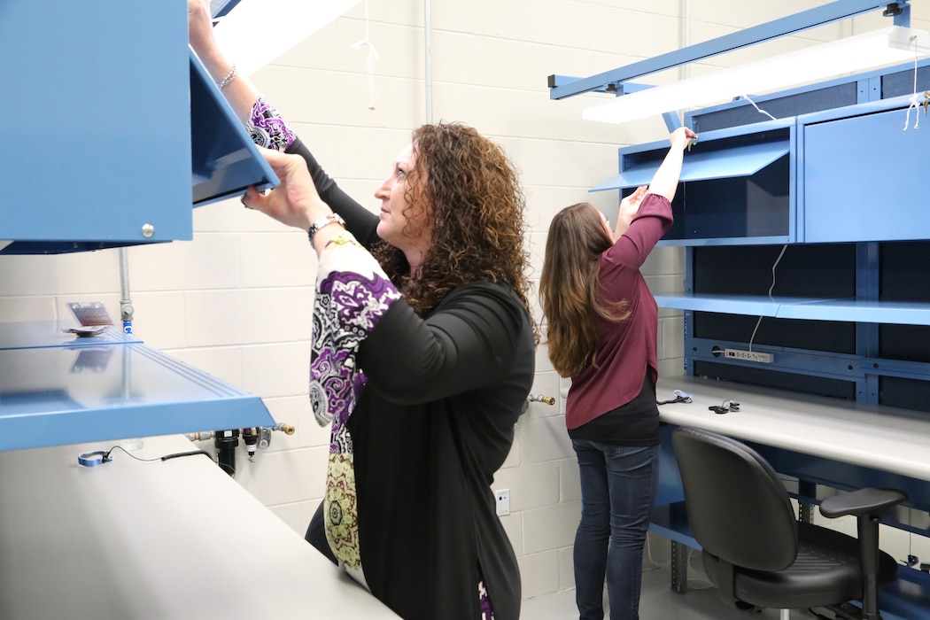 Leslie Yarbrough (left), program manager, and Sara Cook, a project manager, U.S. Army Engineering and Support Center Huntsville Furnishings Program, complete a quality assurance inspection on equipment purchased as part of a $385,000 project within the Gray Eagle Unmanned Aerial System (UAS) cantonment area that included a company operations facility, tactical equipment maintenance facility, operations and storage facility, and control tower.