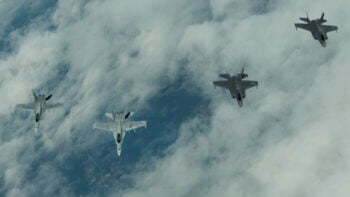 F-35s fly with Finnish F-18s