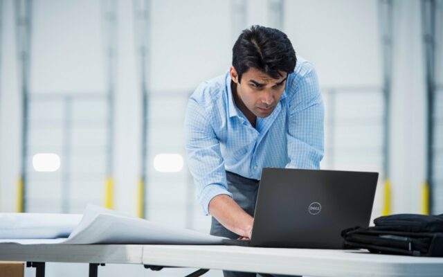 Male team member working remotely using Dell Latitude 14 7480 laptop.