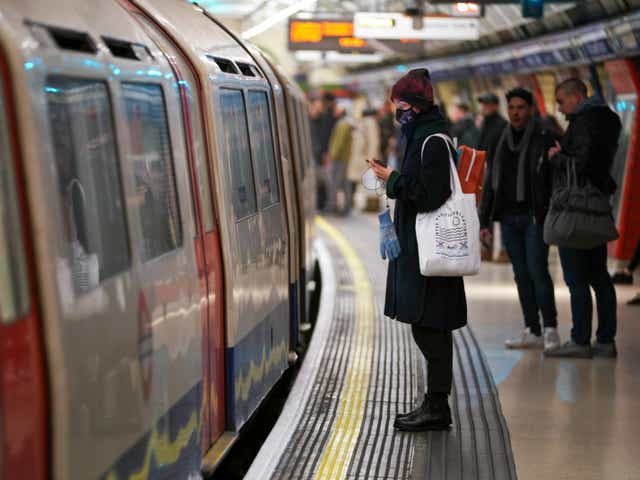 <p>Passenger on the London Underground wears a surgical mask</p>