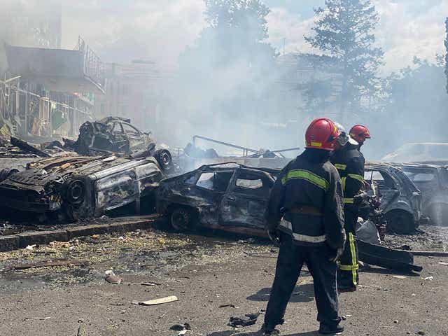 <p>Firefighters work to extinguish a blaze in a building damaged by shelling, in Vinnytsia</p>