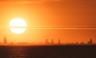 The sun sets behind Chicago's skyline as seen from Indiana Dunes State Park in Chesterton, Indiana.