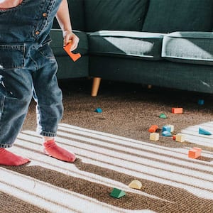 Child playing with toys on living room carpet