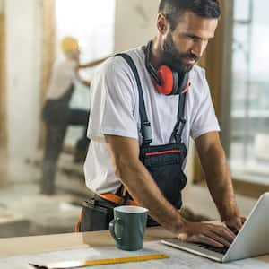 A contractor using his laptop on a construction site