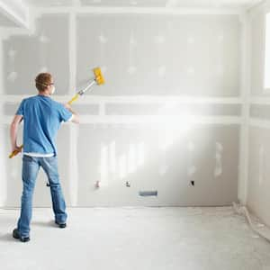 A man working on drywall